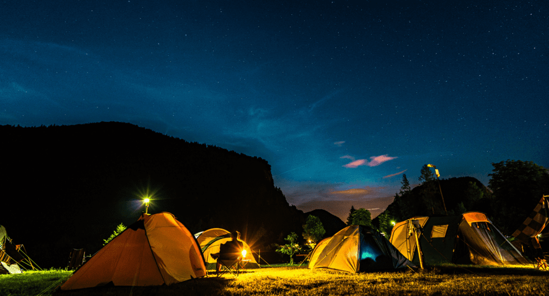 backpacking group campsite with tents taken at night under the sky