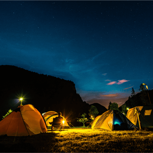 backpacking group campsite with tents taken at night under the sky
